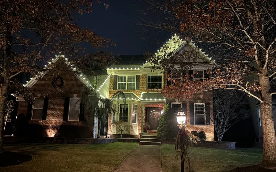 Roofline lighting with a lit wreath over the entrance
